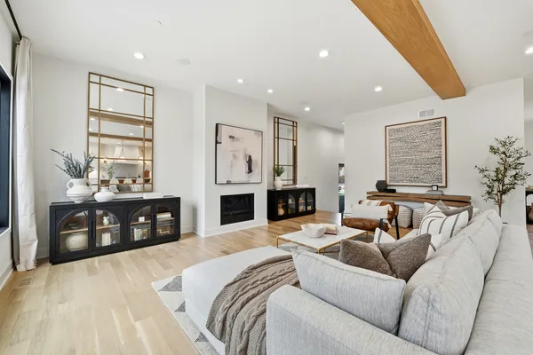 a living room with furniture and large windows