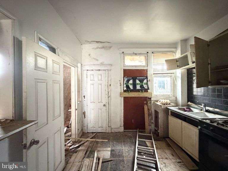 3923 Ridgewood Avenue Baltimore, MD 21215 - Photo 16 of 18 a kitchen with stainless steel appliances a refrigerator and a stove top oven