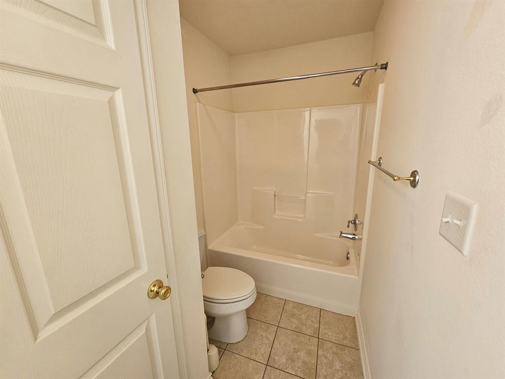 1521 Rice Road, Unit Z101 Tyler, TX 75703 - Photo 19 of 25 White paneled door with a brass knob