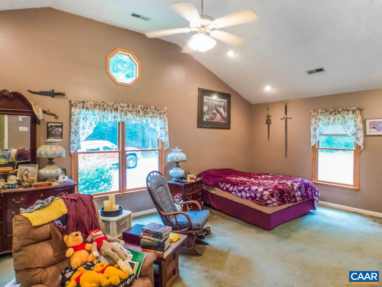 502 Bybees Church Road Palmyra, VA 22963 - Photo 11 of 15 a bedroom with a bed and a chandelier