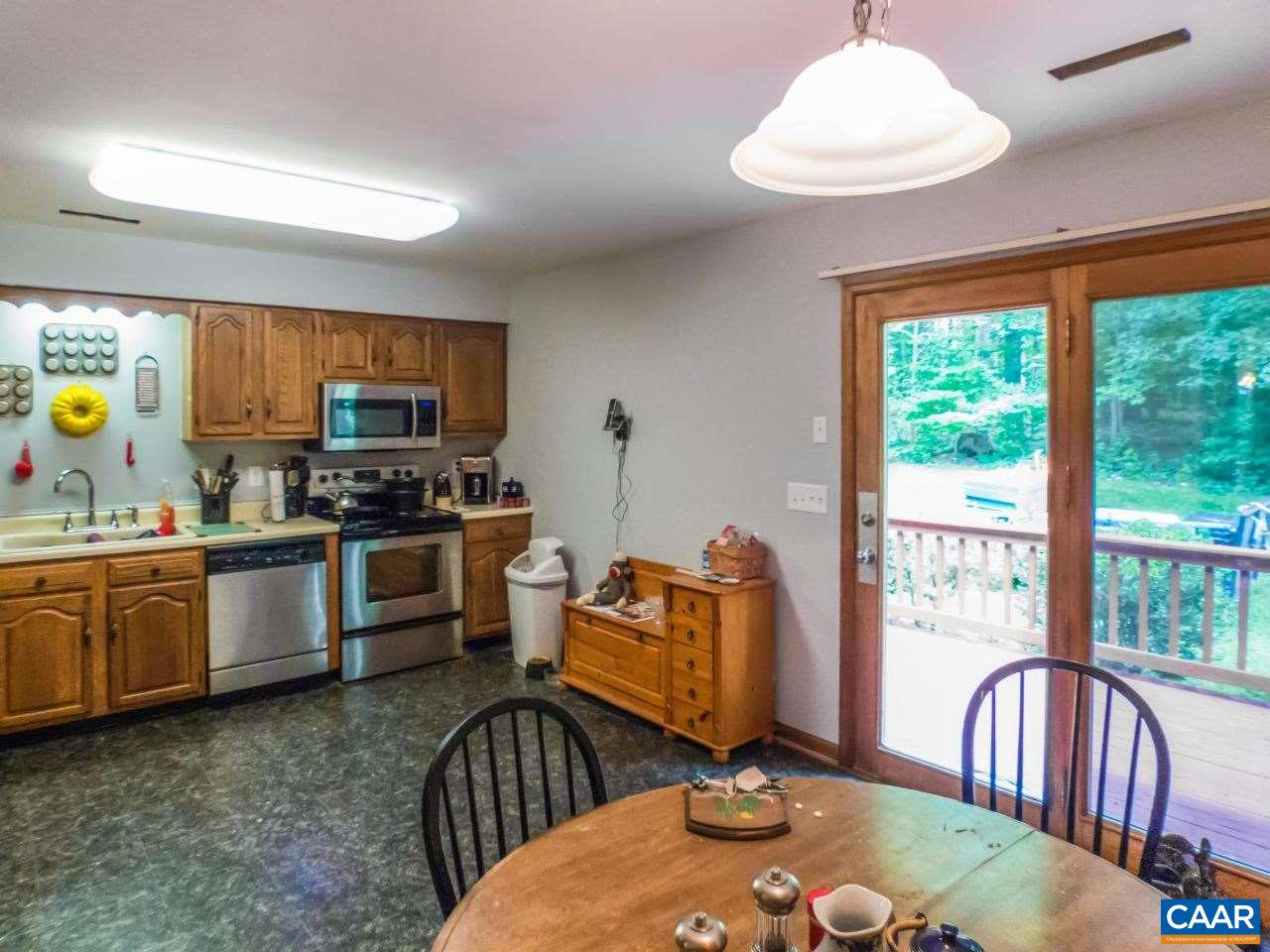 502 Bybees Church Road Palmyra, VA 22963 - Photo 4 of 15 a kitchen with sink refrigerator dining table and chairs
