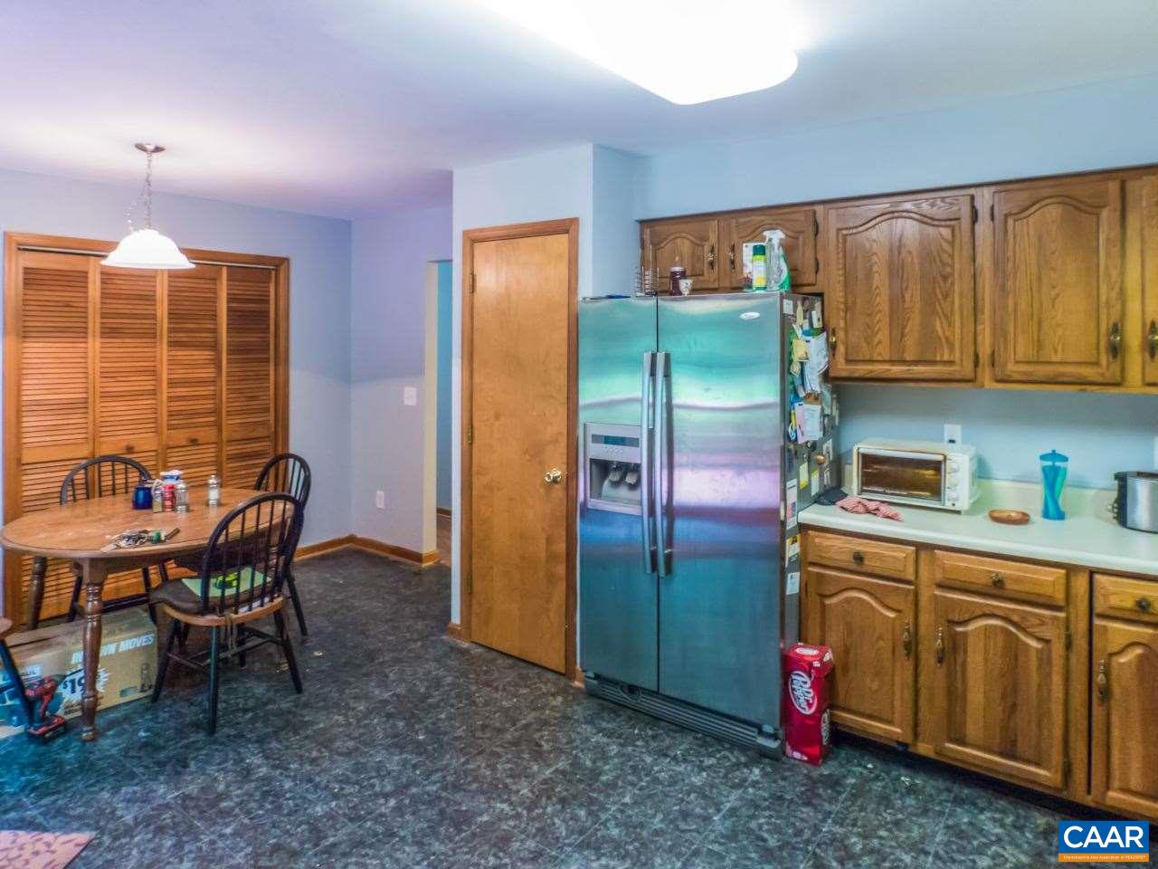 502 Bybees Church Road Palmyra, VA 22963 - Photo 6 of 15 a kitchen with stainless steel appliances granite countertop a refrigerator a stove a sink dishwasher with a dining table and chair