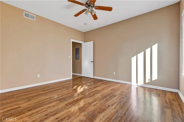 wooden floor in an empty room with a window