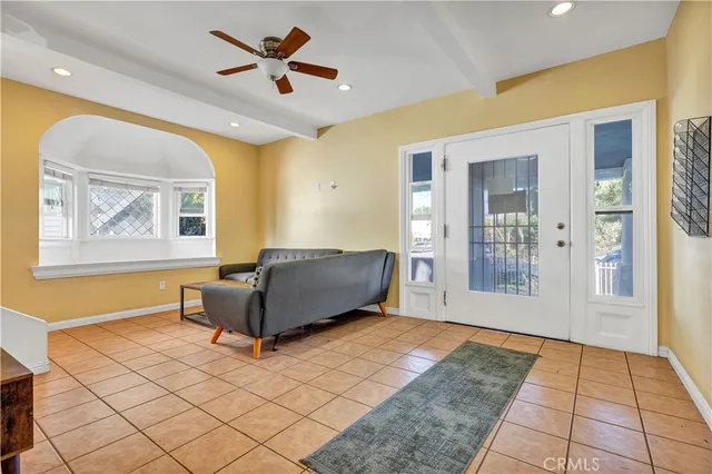 a living room with couches and painting on the wall