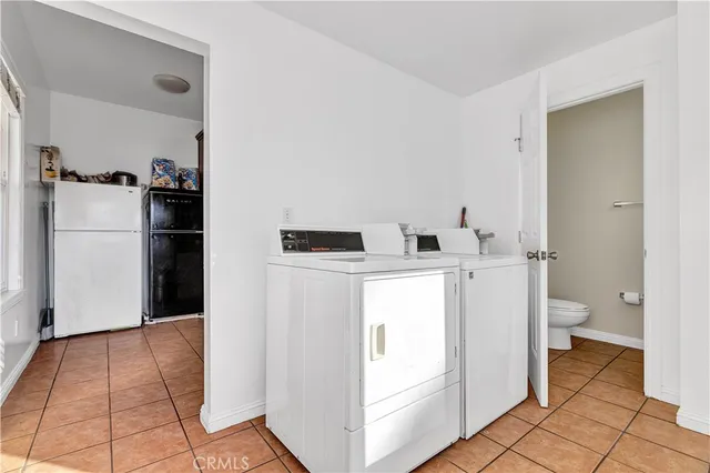 a utility room with cabinets washer and dryer