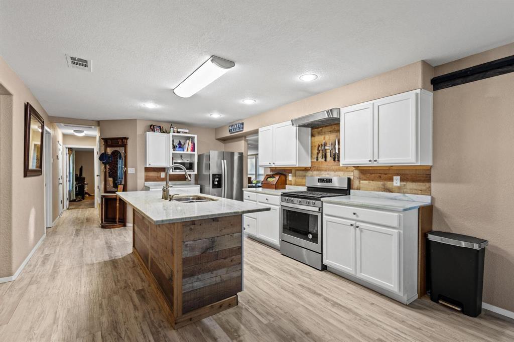 469 Dugan Chapel Road Bells, TX 75414 - Photo 14 of 33 a large kitchen with stainless steel appliances granite countertop a stove and a sink