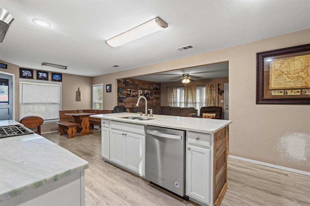 469 Dugan Chapel Road Bells, TX 75414 - Photo 16 of 33 a kitchen with sink refrigerator and couches