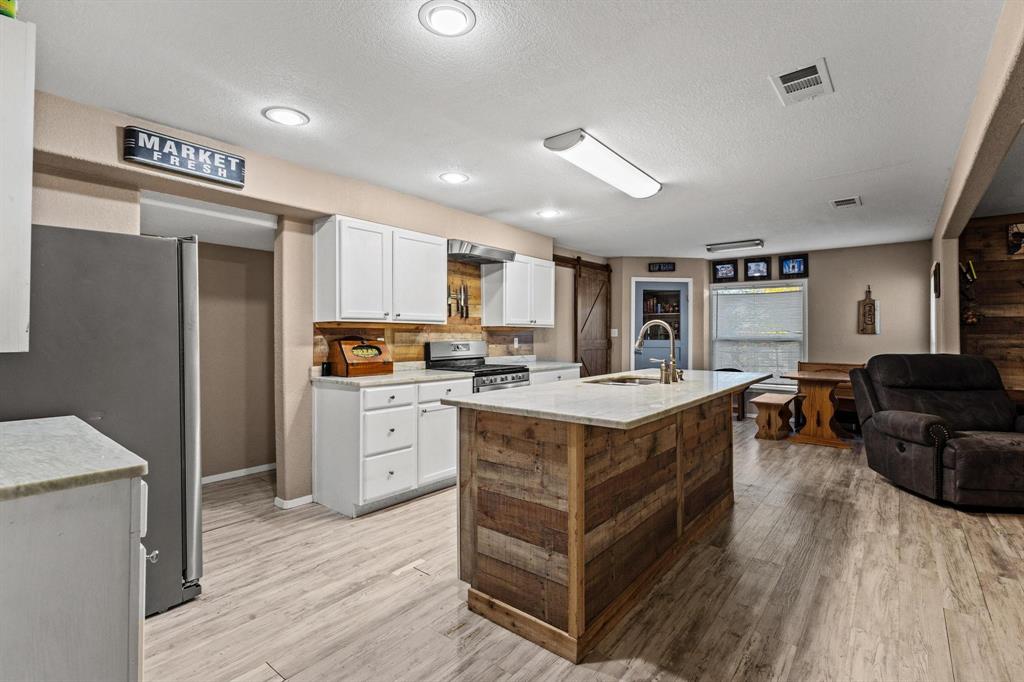 469 Dugan Chapel Road Bells, TX 75414 - Photo 22 of 33 a kitchen with a refrigerator a sink dishwasher stove and oven with wooden floor
