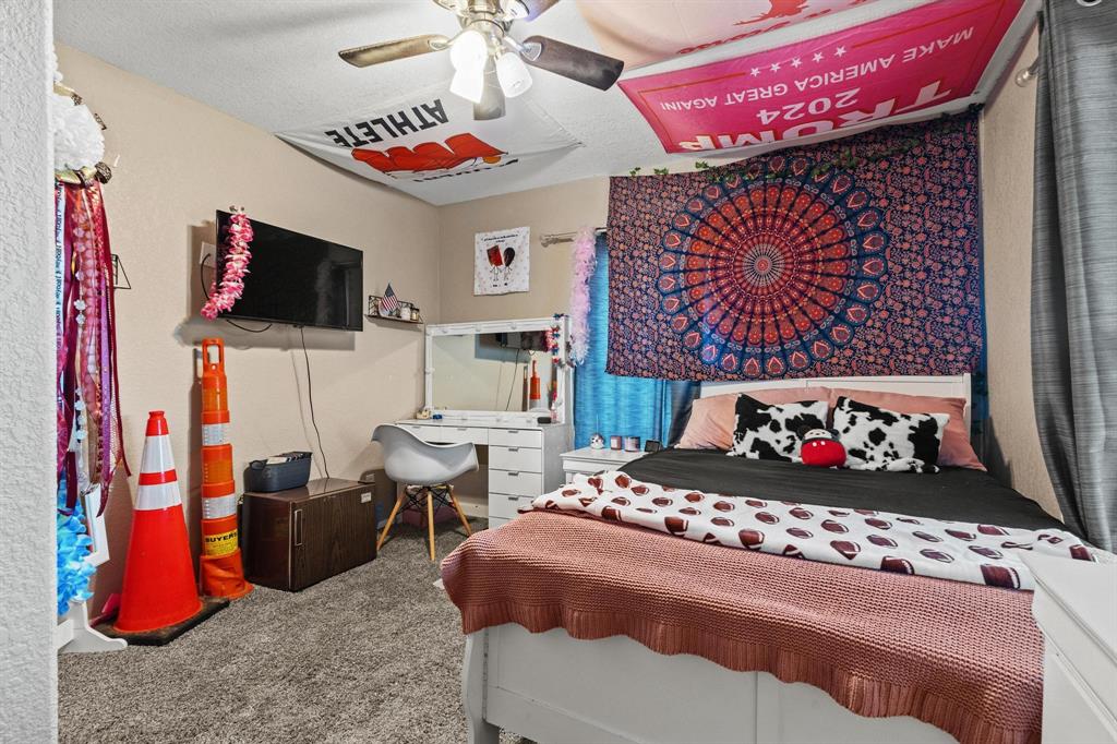 469 Dugan Chapel Road Bells, TX 75414 - Photo 27 of 33 a bedroom with a bed and flat screen tv