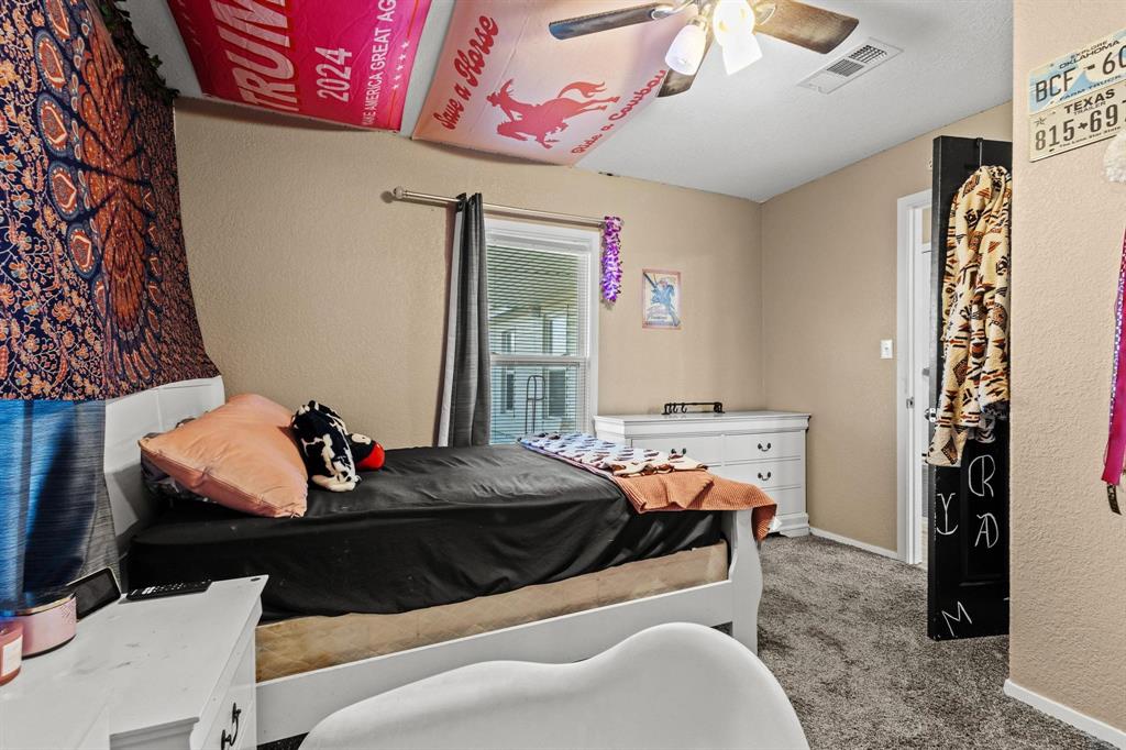 469 Dugan Chapel Road Bells, TX 75414 - Photo 28 of 33 a bed room with a bed and a couch