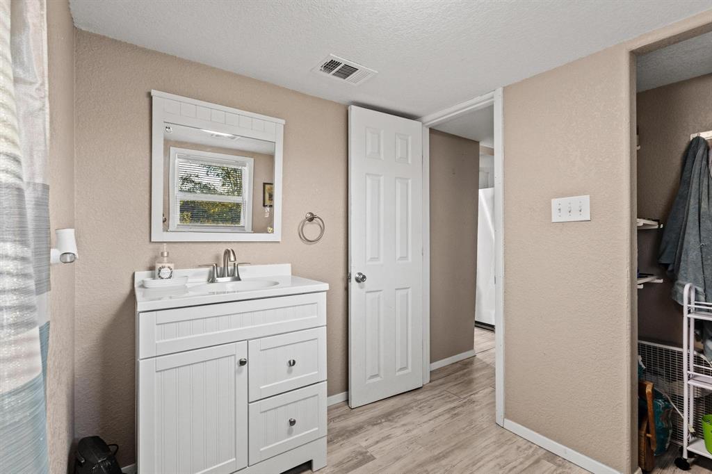 469 Dugan Chapel Road Bells, TX 75414 - Photo 30 of 33 a bathroom with a toilet a sink a mirror and vanity