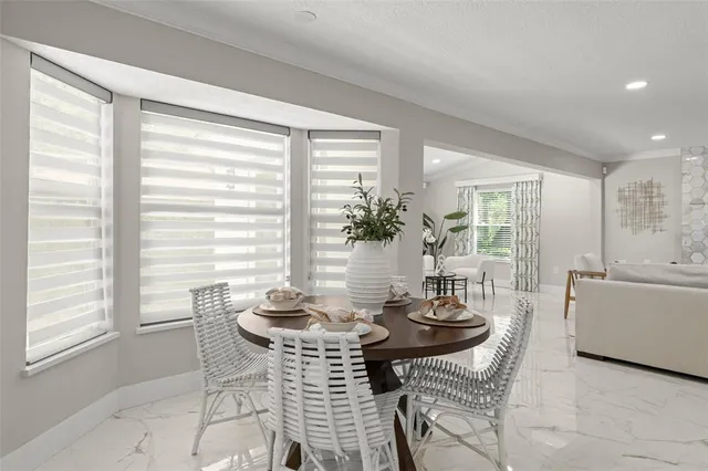 a living room with furniture a fireplace and a large window