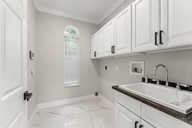 a living room with furniture and a dining table with potted plants