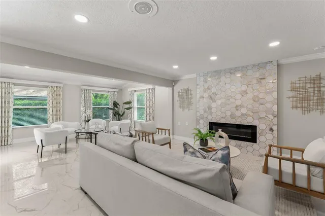 a living room with furniture potted plant and a window