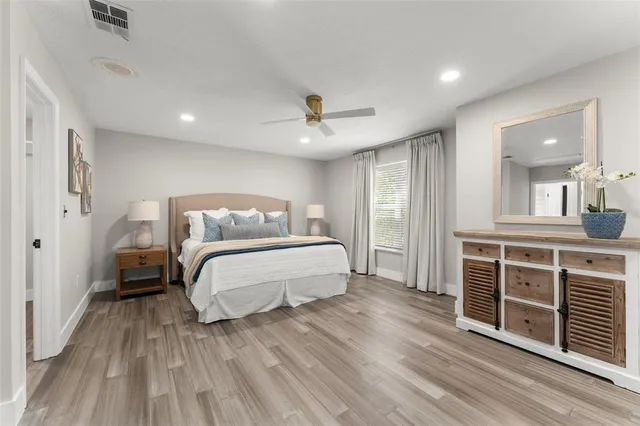 a bedroom with a bed and a couch