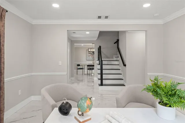 a living room with furniture and flowers