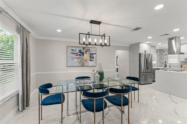 a view of a dining room with furniture and a chandelier