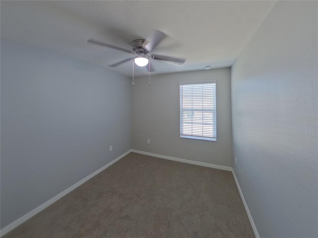 Undisclosed Address Riverview, FL 33578 - Photo 12 of 15 an empty room with a window and a fan