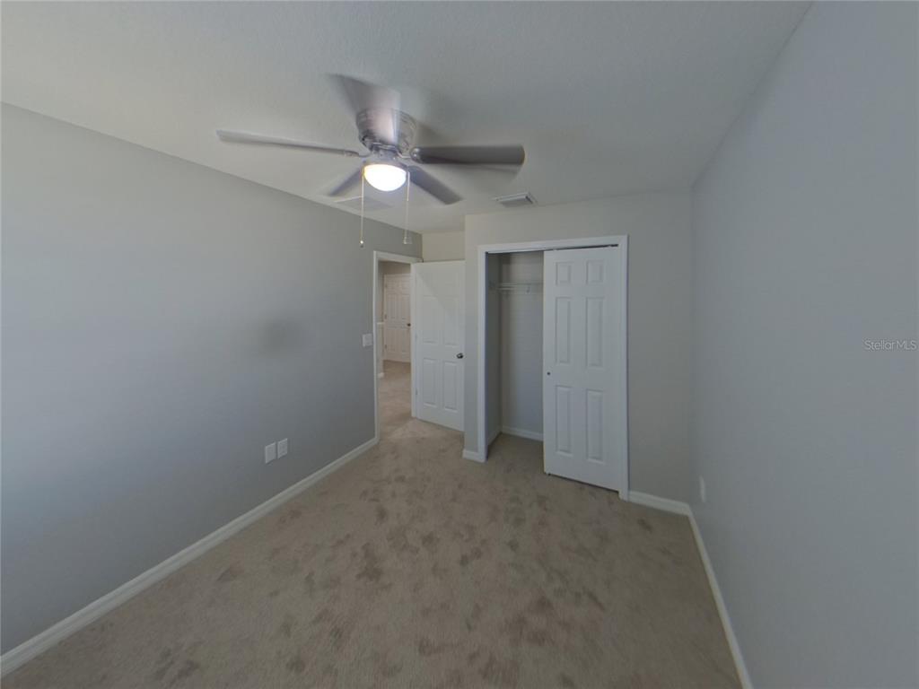 Undisclosed Address Riverview, FL 33578 - Photo 13 of 15 an empty room with a ceiling fan and a window