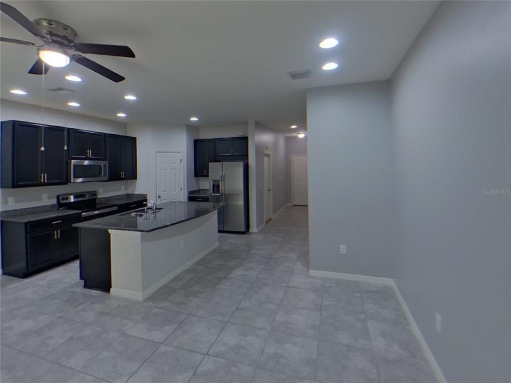 Undisclosed Address Riverview, FL 33578 - Photo 2 of 15 a large kitchen with stainless steel appliances a large counter top