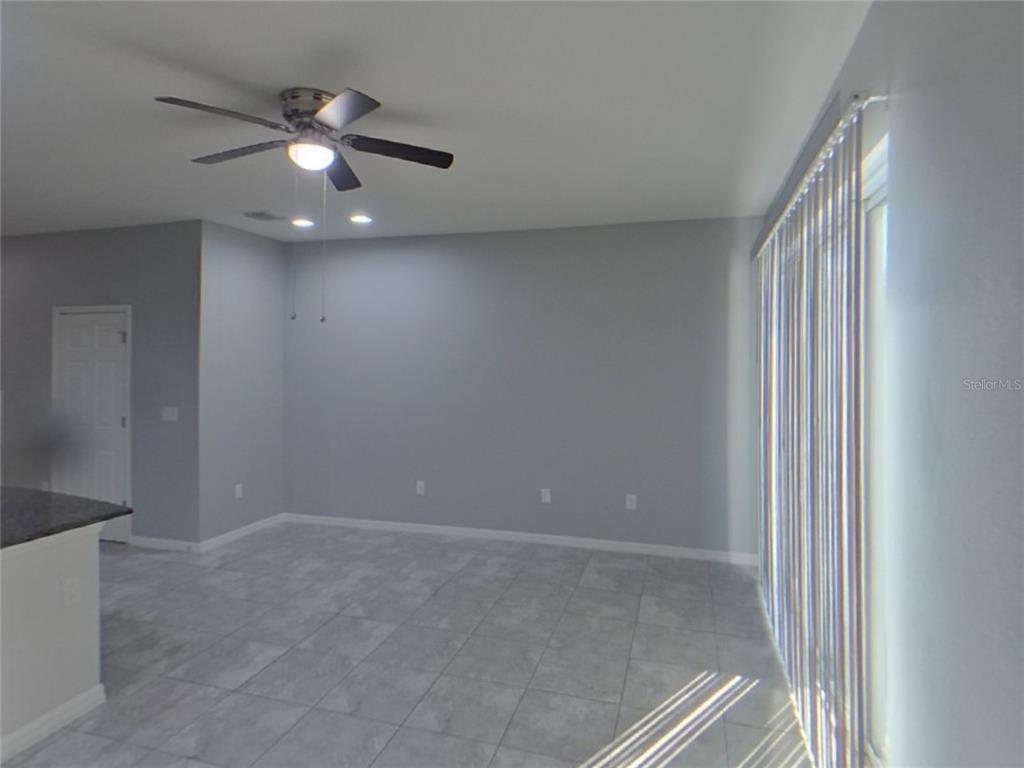 Undisclosed Address Riverview, FL 33578 - Photo 3 of 15 wooden floor in an empty room with a window