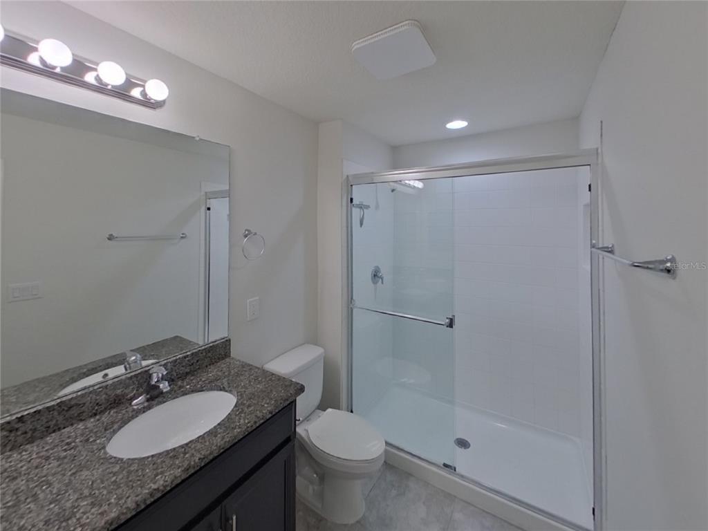 Undisclosed Address Riverview, FL 33578 - Photo 8 of 15 a bathroom with a granite countertop sink toilet a mirror and shower