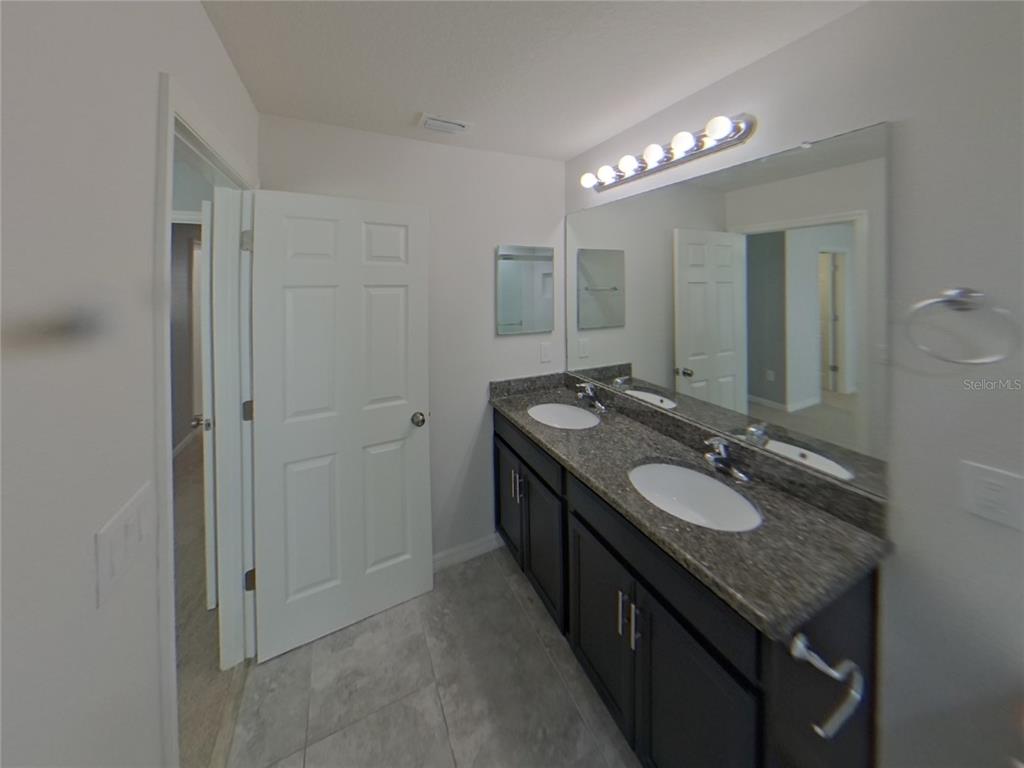 Undisclosed Address Riverview, FL 33578 - Photo 9 of 15 a bathroom with a granite countertop sink a large mirror and a mirror