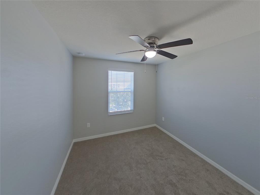 Undisclosed Address Riverview, FL 33578 - Photo 10 of 15 an empty room with a window and a fan