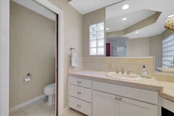 a kitchen with a refrigerator and a sink