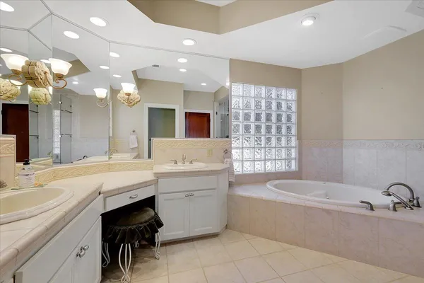 a bedroom with a large bed and wooden floor