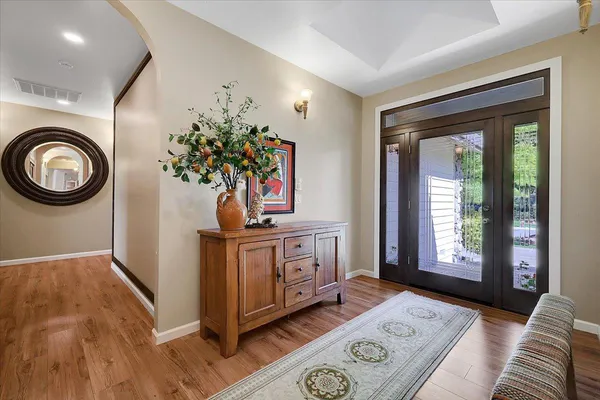 a en suite bathroom with a granite countertop sink toilet and mirror