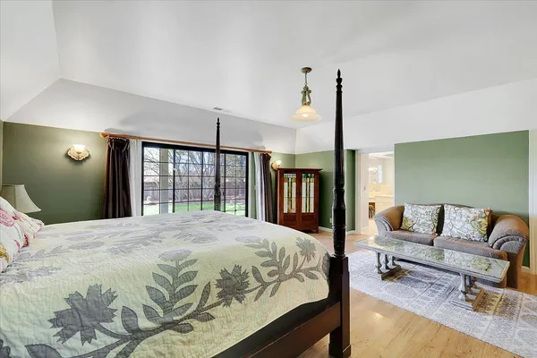 a dining room with furniture a chandelier and wooden floor