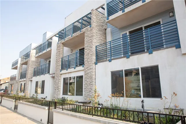 a view of a brick house with large windows