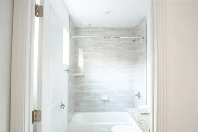 a bathroom with a glass shower door