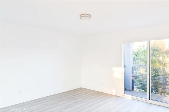 a view of a room with wooden floor and windows