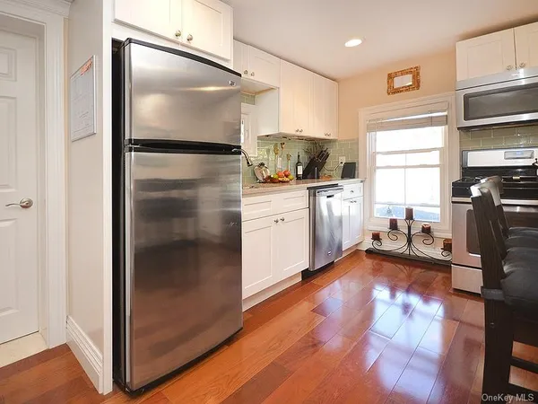 a kitchen with a refrigerator and a stove top oven