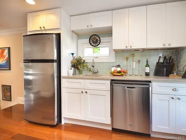 a kitchen with stainless steel appliances granite countertop a refrigerator and a stove top oven