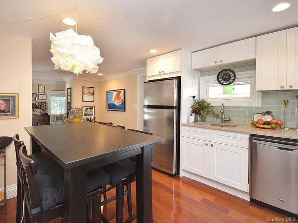 a kitchen with a refrigerator and a stove top oven