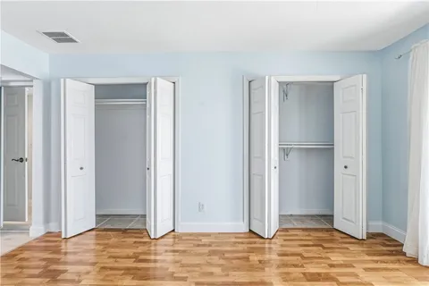 a view of a livingroom with a chandelier fan and wooden floor