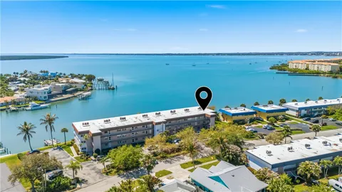 an aerial view of a house with a lake view