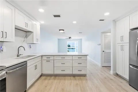 a view of a kitchen with microwave and cabinets
