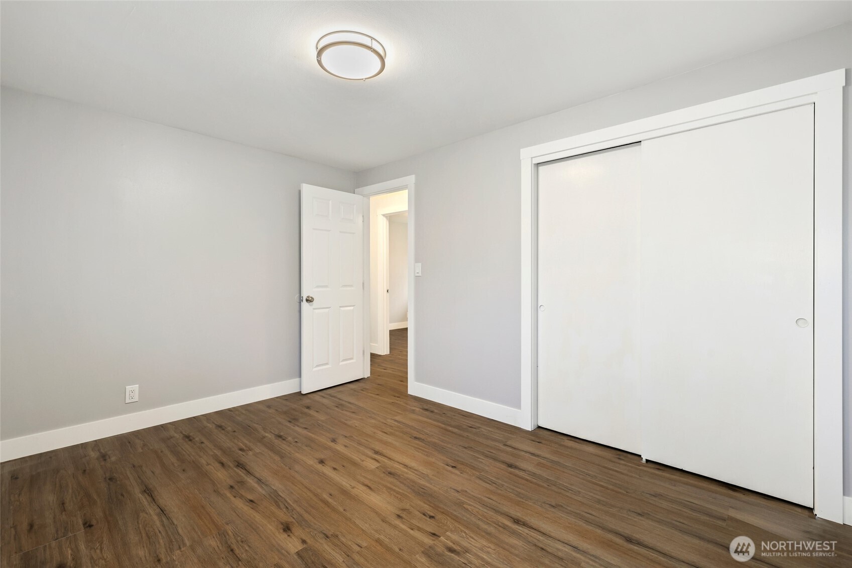 12637 Southeast 161st Street Renton, WA 98058 - Photo 12 of 37 an empty room with wooden floor and windows