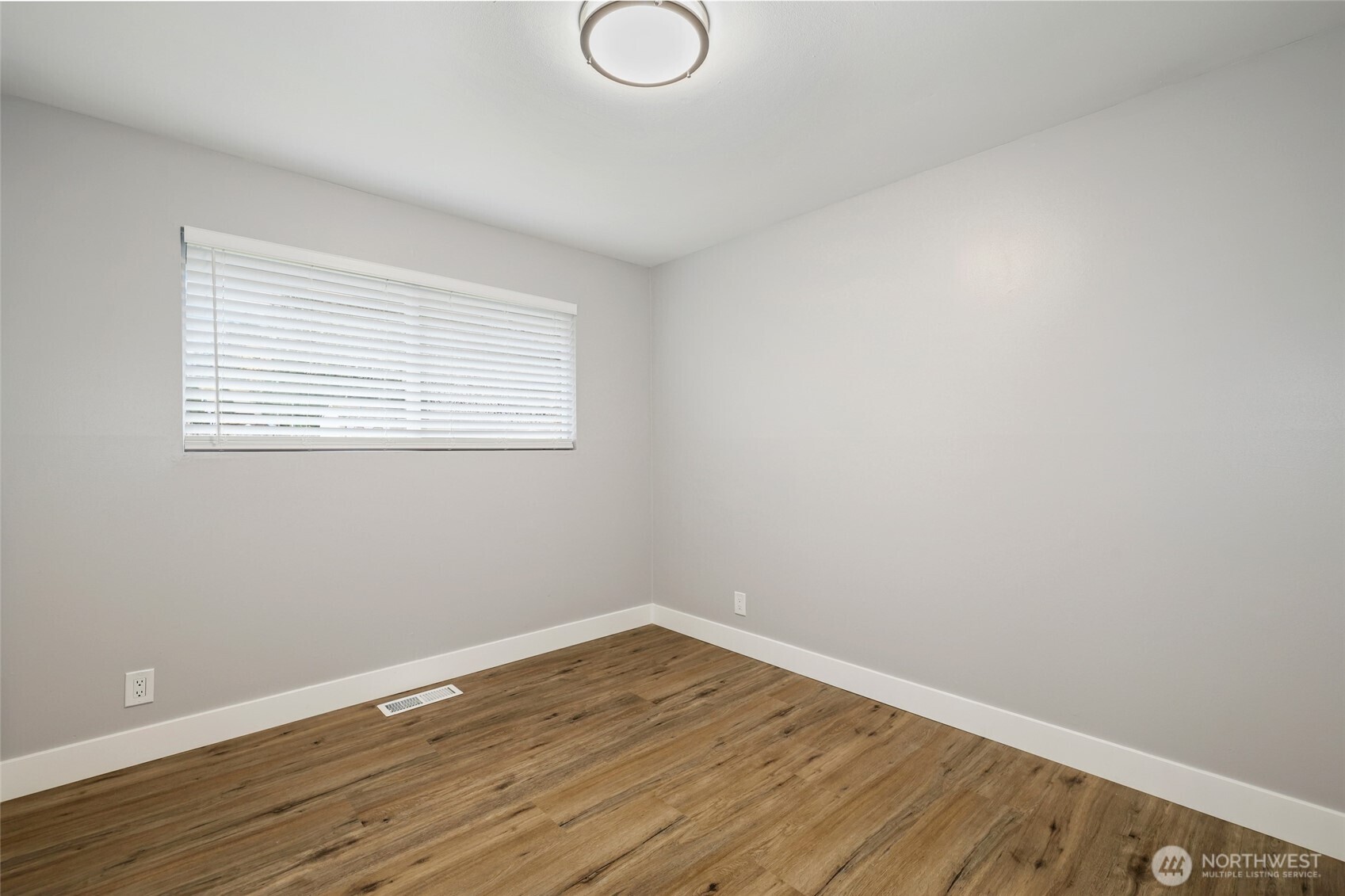 12637 Southeast 161st Street Renton, WA 98058 - Photo 13 of 37 wooden floor in an empty room with a window