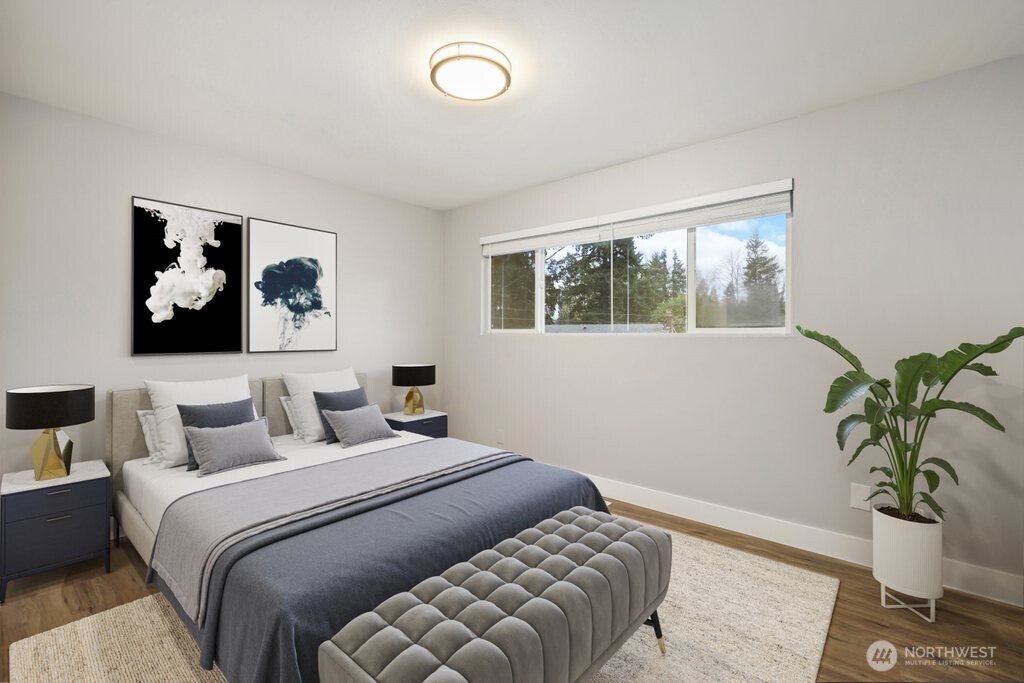 12637 Southeast 161st Street Renton, WA 98058 - Photo 14 of 37 a bedroom with a bed and glass window