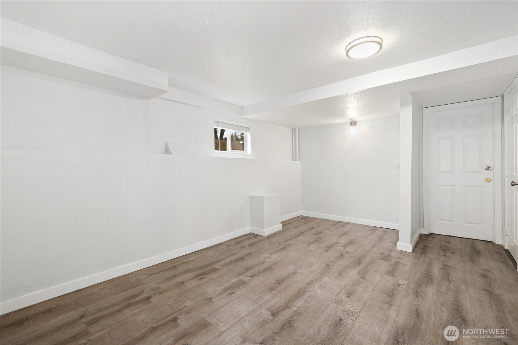 12637 Southeast 161st Street Renton, WA 98058 - Photo 24 of 37 an empty room with wooden floor