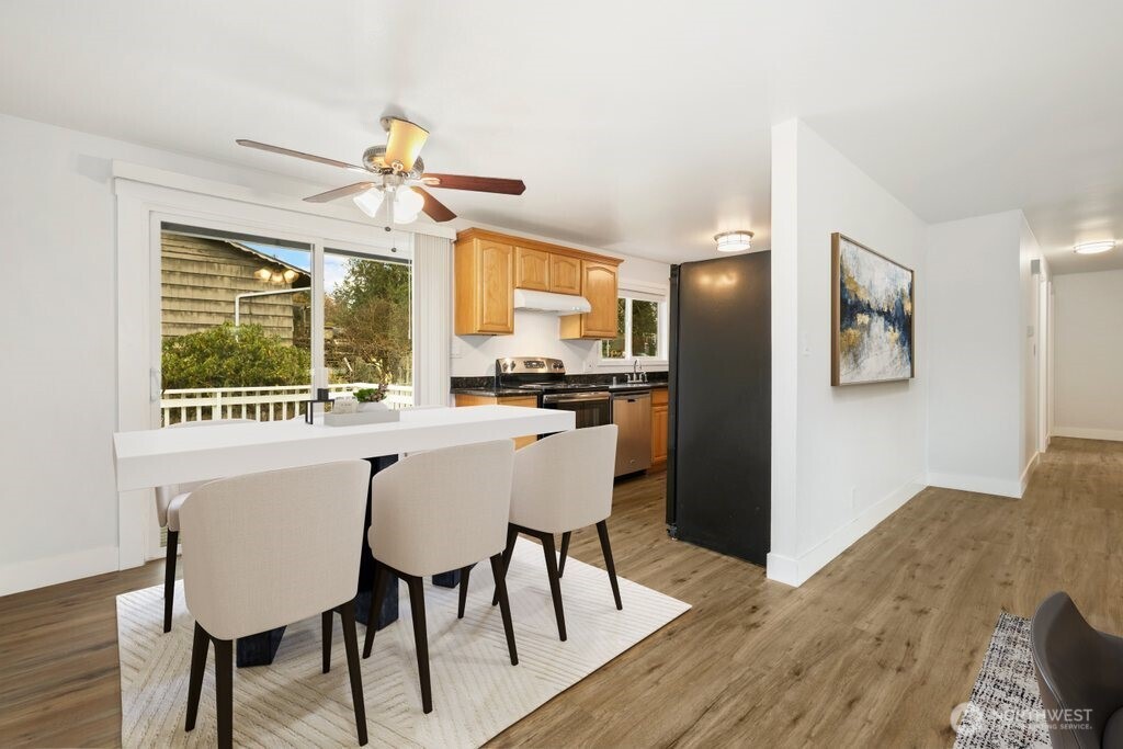 12637 Southeast 161st Street Renton, WA 98058 - Photo 6 of 37 a view of a dining room with furniture window and wooden floor