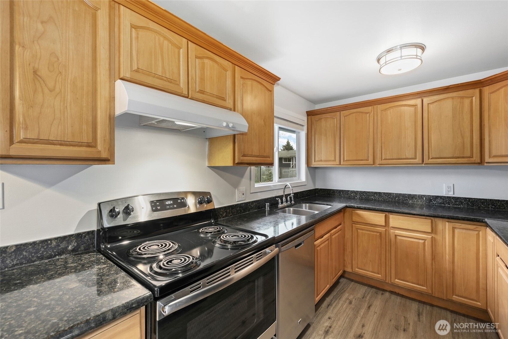 12637 Southeast 161st Street Renton, WA 98058 - Photo 7 of 37 a kitchen with stainless steel appliances granite countertop a stove and a sink