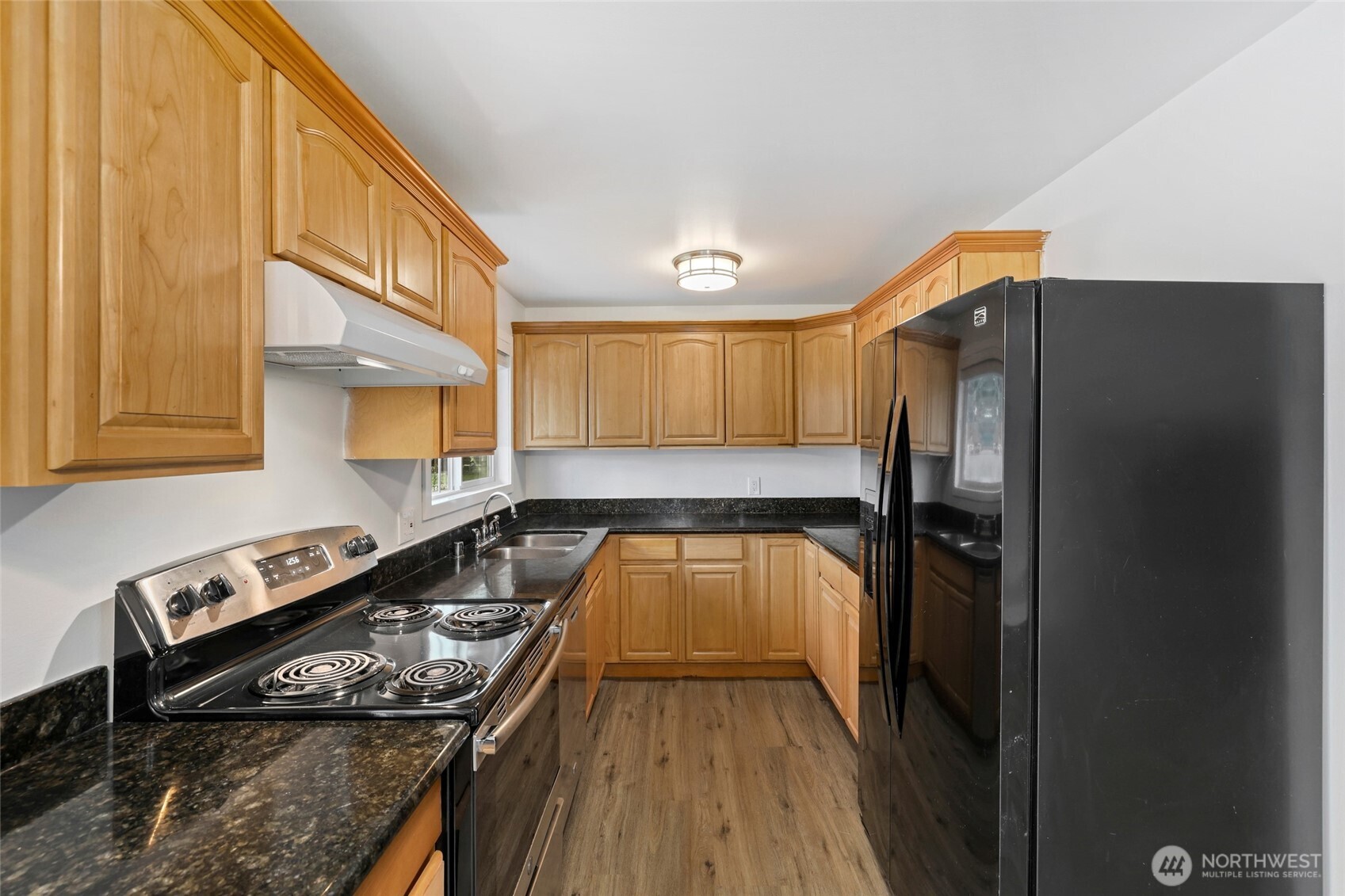 12637 Southeast 161st Street Renton, WA 98058 - Photo 9 of 37 a kitchen with a stove and a refrigerator