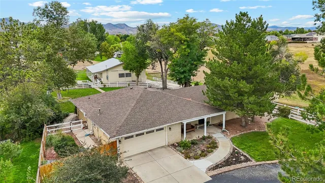 aerial view of a house with a yard and potted plants