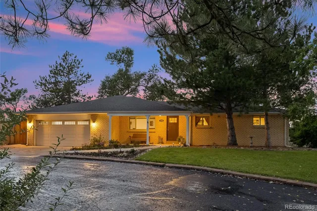 a view of a backyard with large trees and plants
